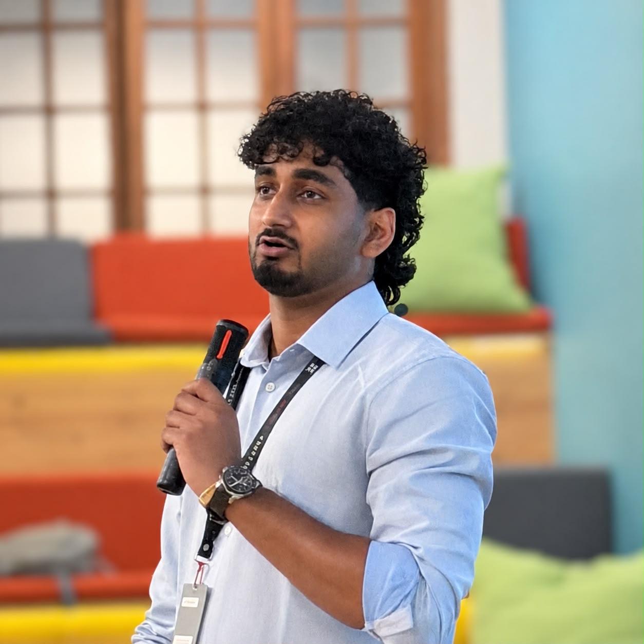 Chamidu mid sentence, microphone in hand